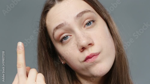 Video of young girl in black shirt with fuck finger, portrait photo