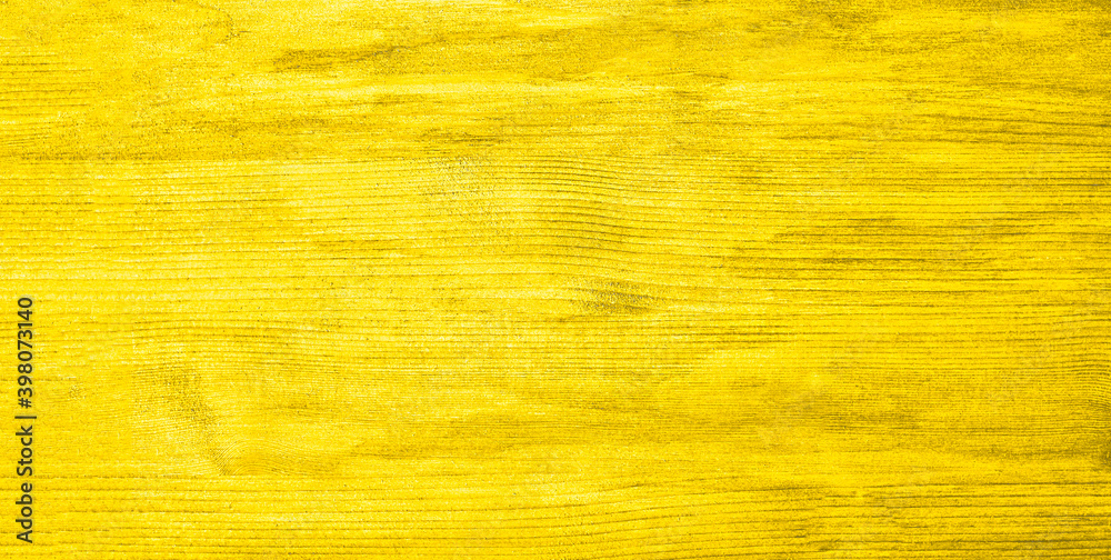 Fototapeta premium Wood yellow textured background in the trendy Mellow Yellow color. copy space