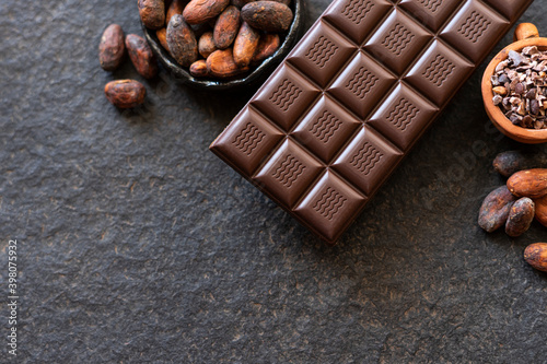 Chocolate, cocoa beans, cocoa slices on a black background