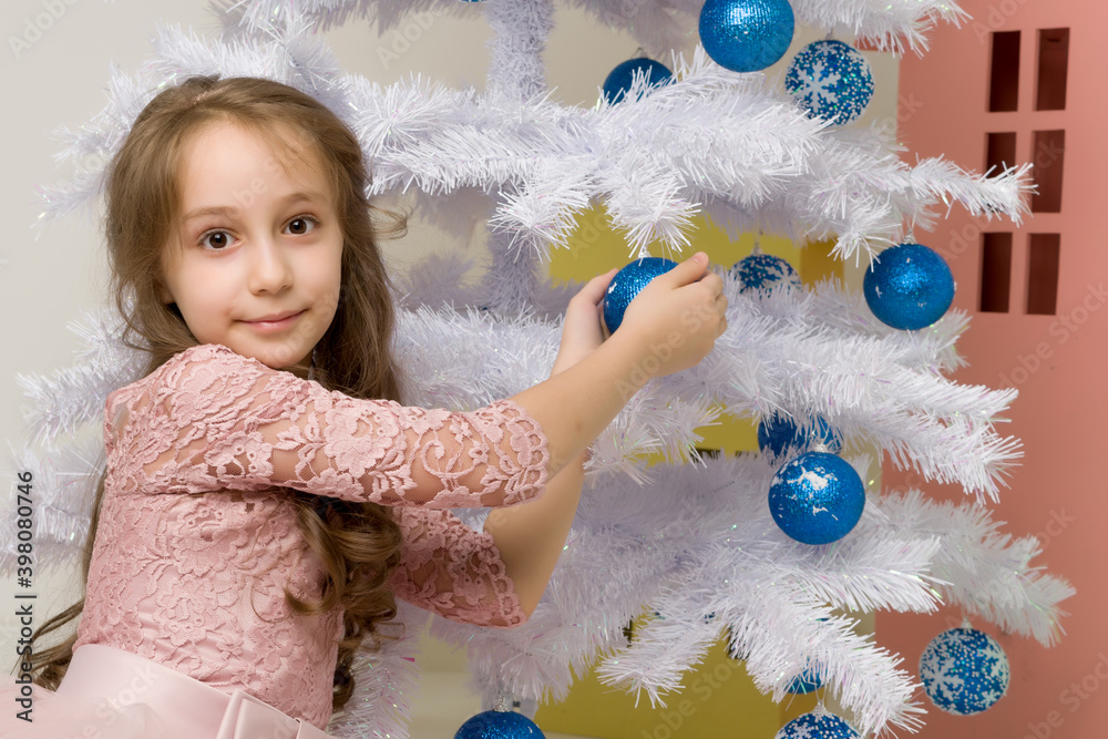 Preteen Girl Posing in Front of White Christmas Tree with Blue Baubles