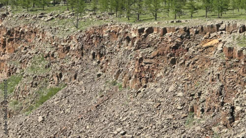 Broken and Crumbled Rocks Spilling From the Canyon Slope Ridge Towards the Valley Floor.volcanic rock layer layers tendency sediments erosion washout denudation slot canyons narrow land landslide 4K. Broken and Crumbled Rocks Spilling From the Canyon Slope Ridge Towards the Valley Floor.volcanic rock layer layers tendency sediments erosion washout denudation slot canyons narrow land landslide 4K.
