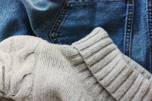 Beige knit sweater and blue jeans 