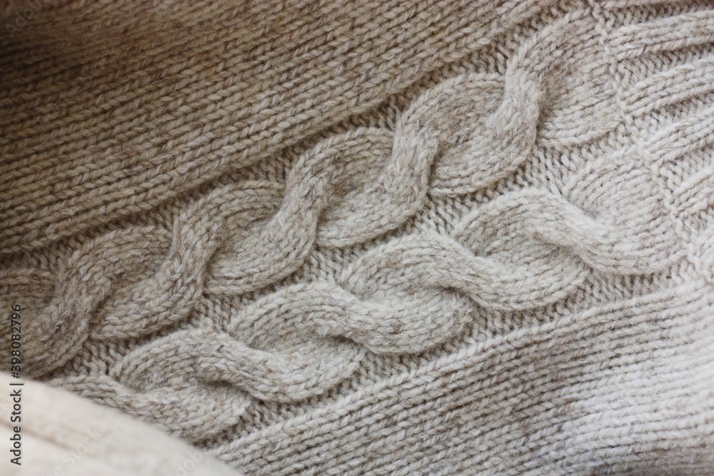 Beautiful beige knitted sweater close up view Beautiful beige knitted sweater close up view