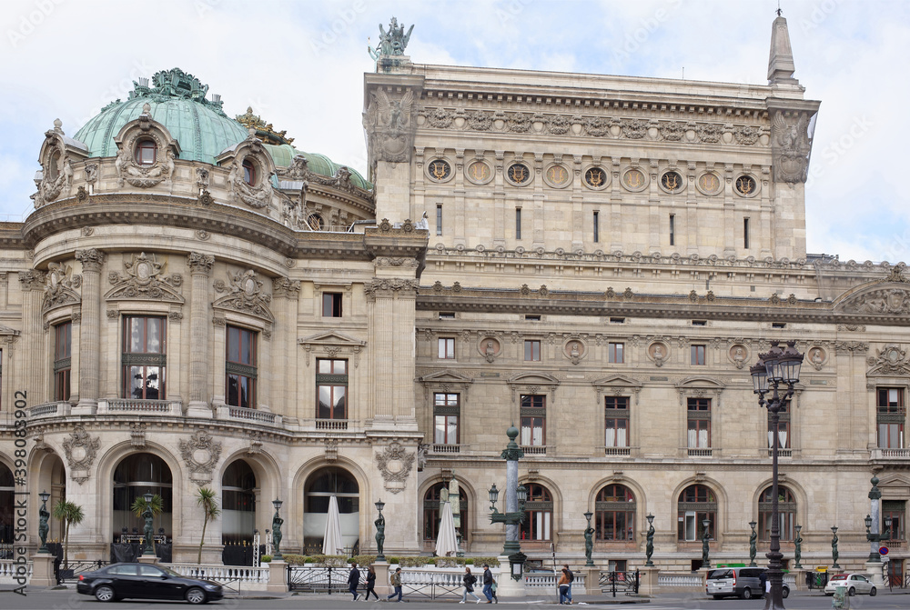   View of the Palais Garnier opera from the street Halevy. On the street pedestrians and moving vehicles