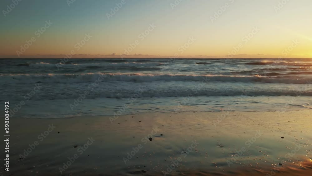 Aerial view of ocean waves during sunset slowly moving forward Aerial view of ocean waves during sunset slowly moving forward