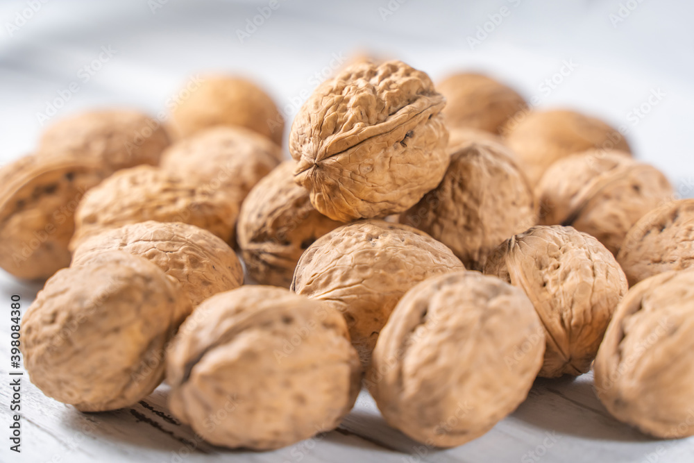 Walnuts kernels on white wooden desk, stock photo Walnuts kernels on white wooden desk, stock photo