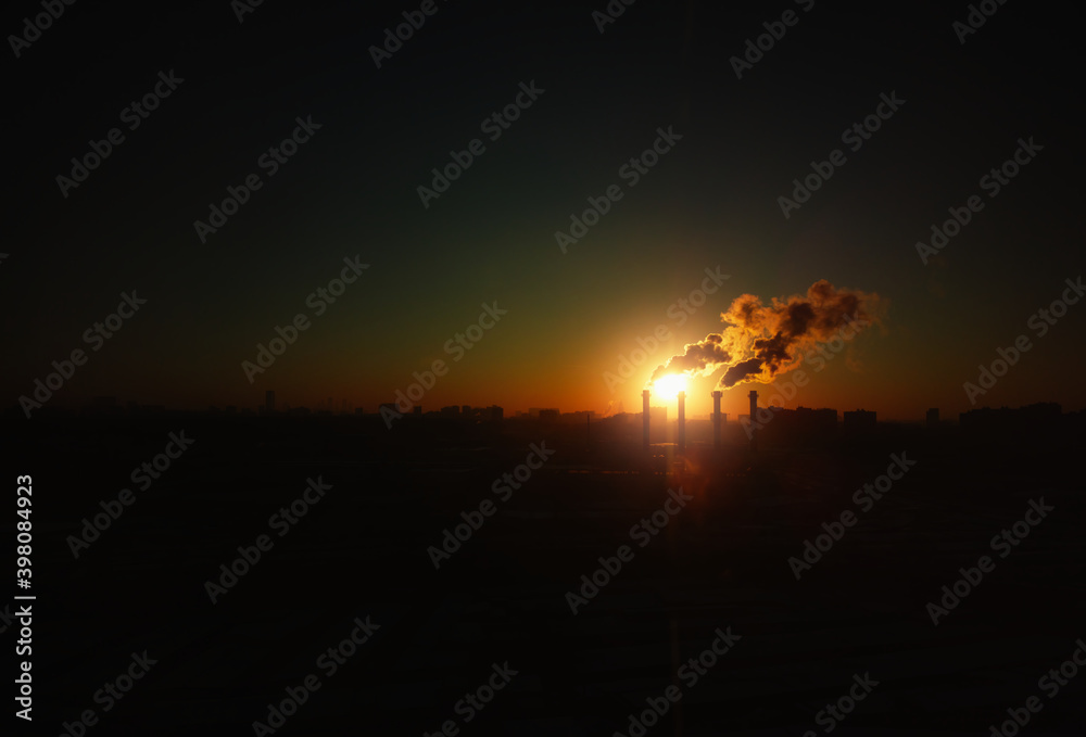 Industrial chimneys during sunset background