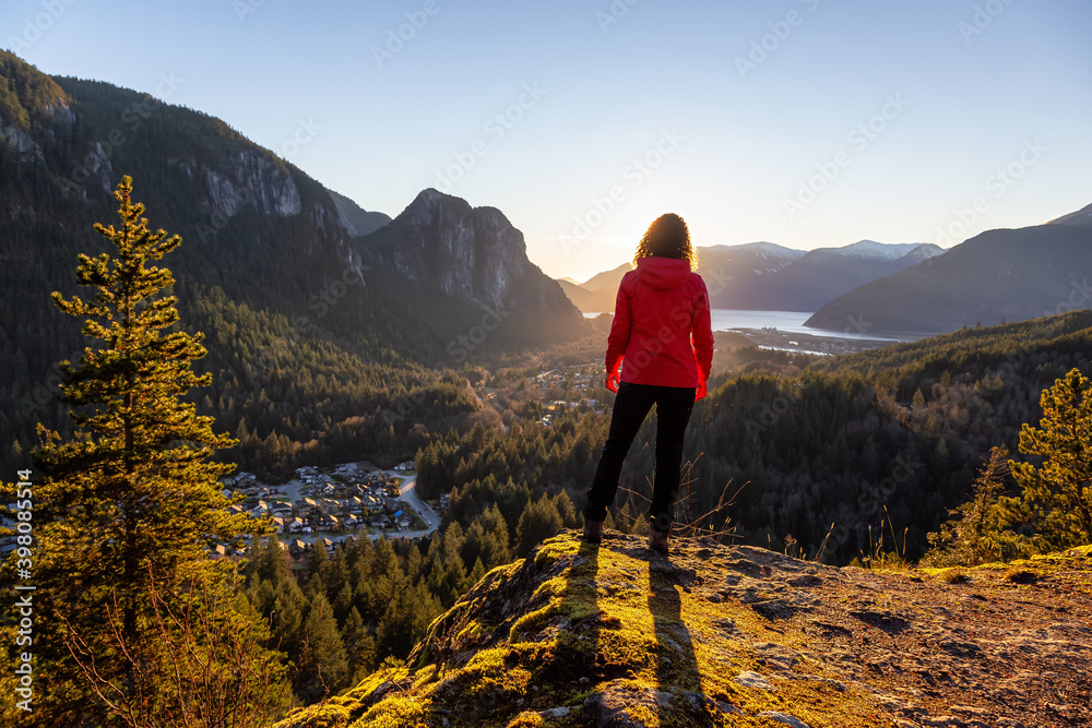 Adventurous Girl Hiking in the mountains during a sunny Autumn Sunset. Taken Squamish, North of Vancouver, British Columbia, Canada. Concept: Adventure, freedom, lifestyle