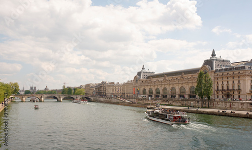 On the river Seine sailing ships with tourists. Pedestrians walk and rest photo