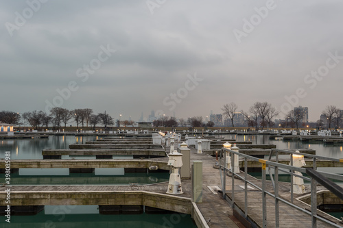 Several empty boat docks sitting on calm water with cloudy sky in Chicago