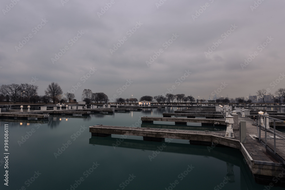 Overcast skies above empty boat docks on calm water in Chicago
