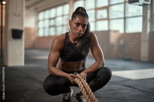 Serious sportswoman with ropes looking at camera photo