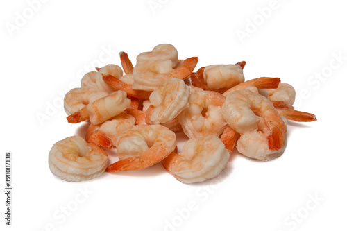 Frozen raw peeled shrimps on a white plate. Isolate. Side view. Copyspace