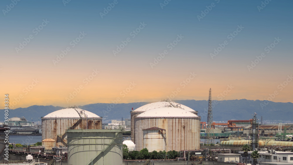 Fototapeta premium Oil refinery petrochemical plant factory from Osaka chemical industry zone of Japan. oil and gas petrochemical industrial. many oil storage tank and pipeline steel. Ecosystem environment concept