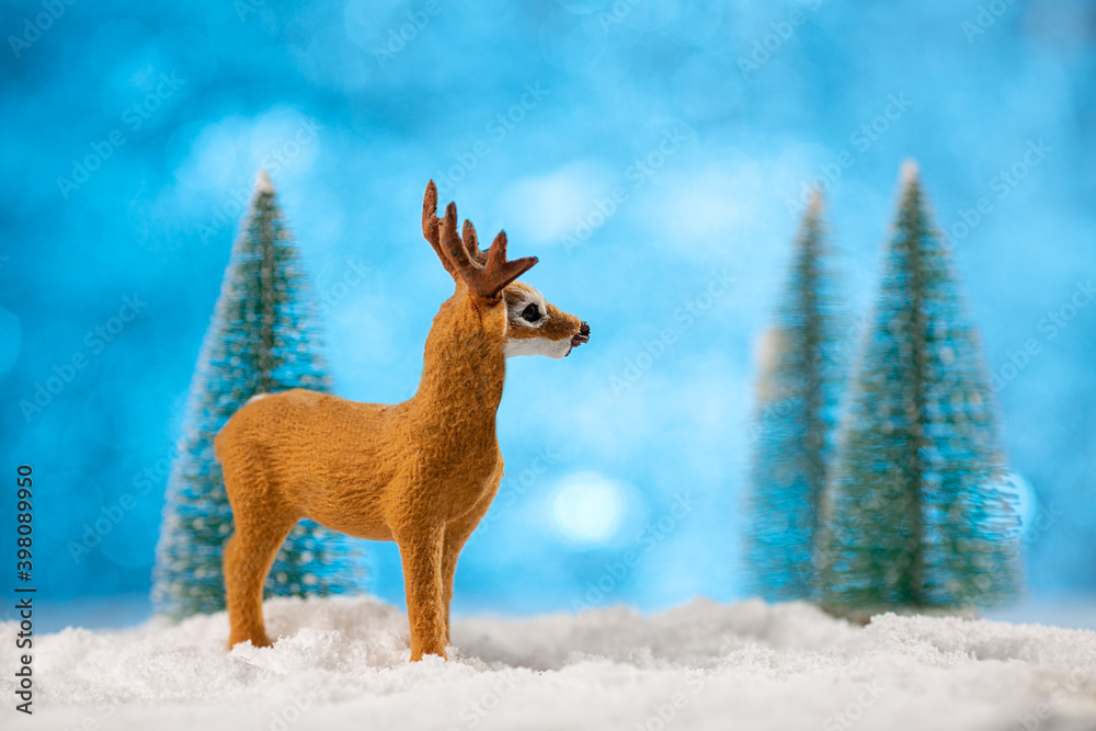 Obraz premium Toy deer made on christmas winter background