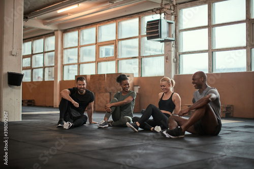 Group of diverse friends talking and laughing after a workout