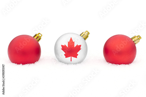 three Christmas balls canada flag in the snow