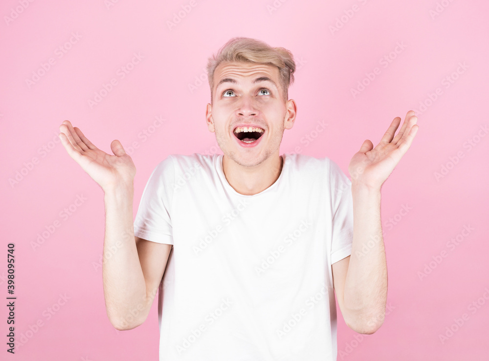 Amazed excited man, keeps hands up, stares at camera, says omg or wow. Happy man rejoicing at good news, information and results. Amazed excited man, keeps hands up, stares at camera, says omg or wow. Happy man rejoicing at good news, information and results.