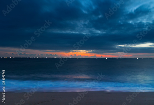 The beautiful sunset scene with fishing boats lit on the sea. Thiruvananthapuram  Kerala  India.