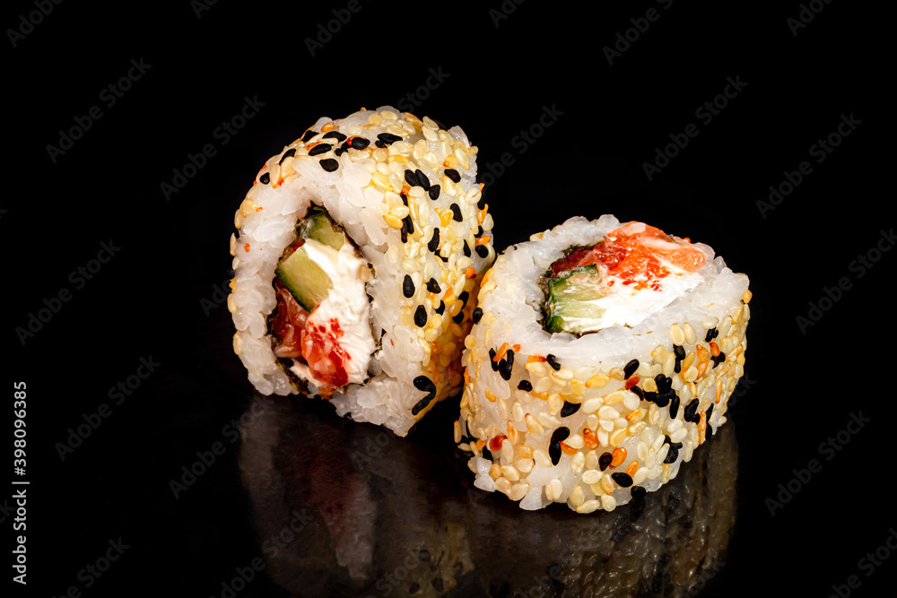 Sushi Sets Uramaki, California, Philadelphia, on a white plate. Festive, New Year concept. Against a dark reflective background. Sushi Sets Uramaki, California, Philadelphia, on a white plate. Festive, New Year concept. Against a dark reflective background.