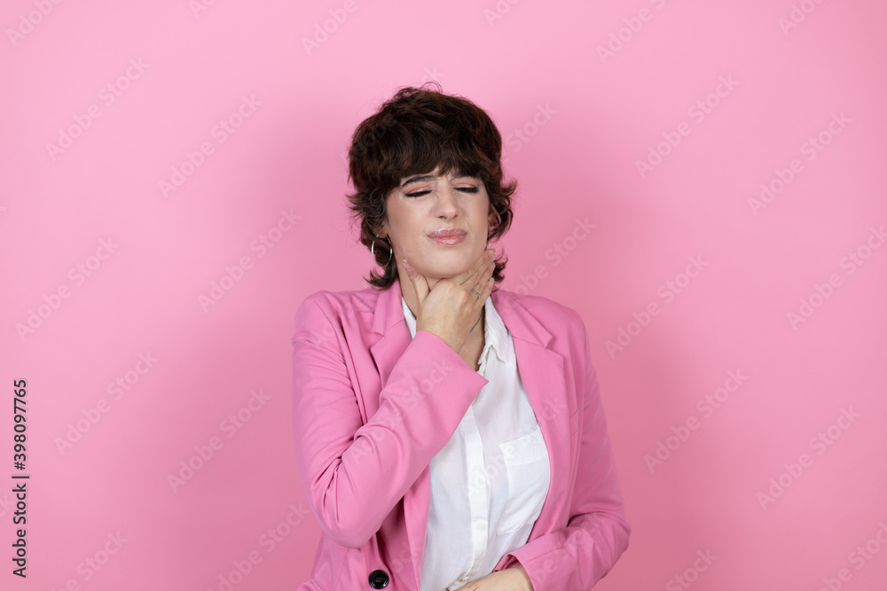 Young business woman over isolated pink background touching painful neck, sore throat for flu, clod and infection Young business woman over isolated pink background touching painful neck, sore throat for flu, clod and infection