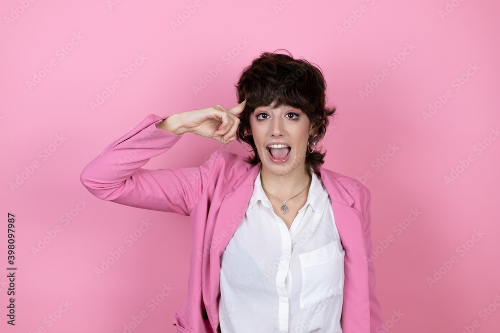 Young business woman over isolated pink background smiling and thinking with her fingers on her head that she has an idea. Young business woman over isolated pink background smiling and thinking with her fingers on her head that she has an idea.