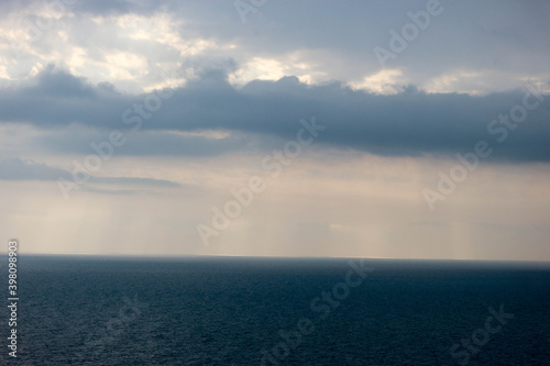 sun rays shine through the stormy clouds over Black sea in Crimea