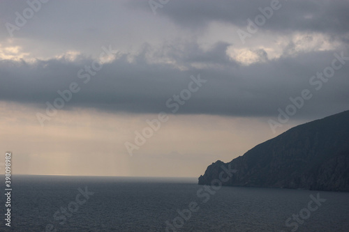 sun rays shine through the stormy clouds over Black sea in Crimea