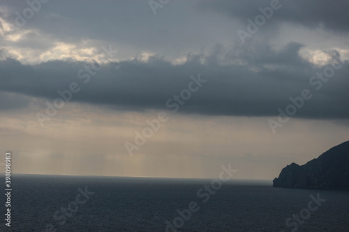 sun rays shine through the stormy clouds over Black sea in Crimea