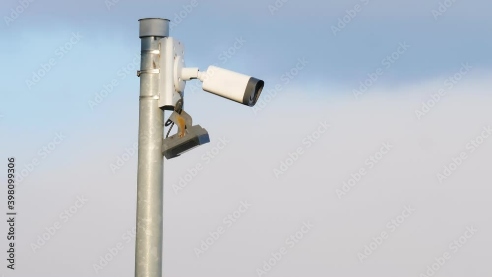 Security camera cctv video surveillance against sky with clouds moving across it. Time lapse. Security camera cctv video surveillance against sky with clouds moving across it. Time lapse.
