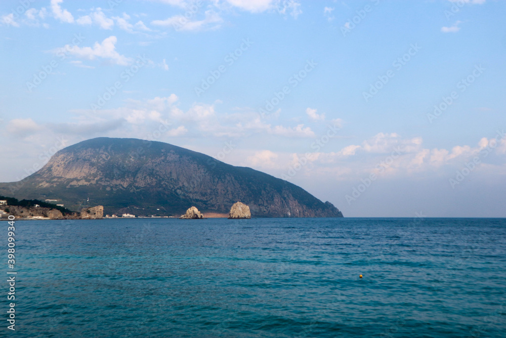 view of the Black sea and mountain Ayu-Dag (sleeping bear) in Crimea under cloudy sky