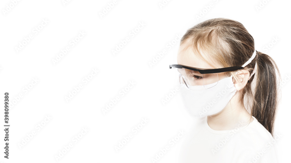 Little Caucasian preschool girl in a medical protection mask pm2.5. side view Baby on white background with copy space. epidemic, pandemic. Coronavirus quarantine. protect loved ones Little Caucasian preschool girl in a medical protection mask pm2.5. side view Baby on white background with copy space. epidemic, pandemic. Coronavirus quarantine. protect loved ones