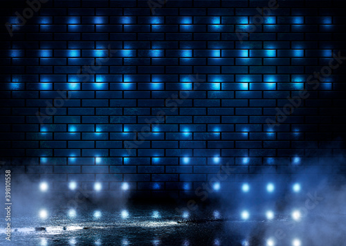 Dark brick wall, blue neon light. Rays and glare of light in the dark. Night view of a dark street, abstract projection on an empty wall.