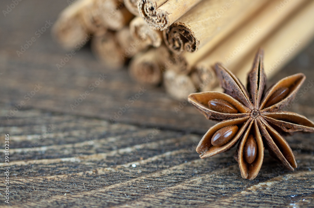 cinnamon sticks and anise on a wooden background cinnamon sticks and anise on a wooden background