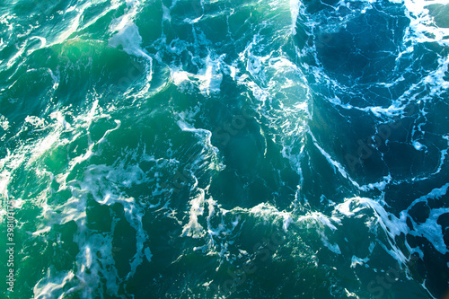 Background shot of clear sea water surface texture tidewater green color