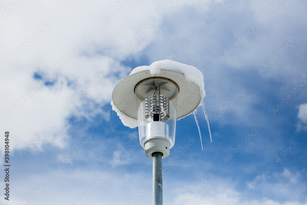 iced street lamp over a blue cloudy sky iced street lamp over a blue cloudy sky