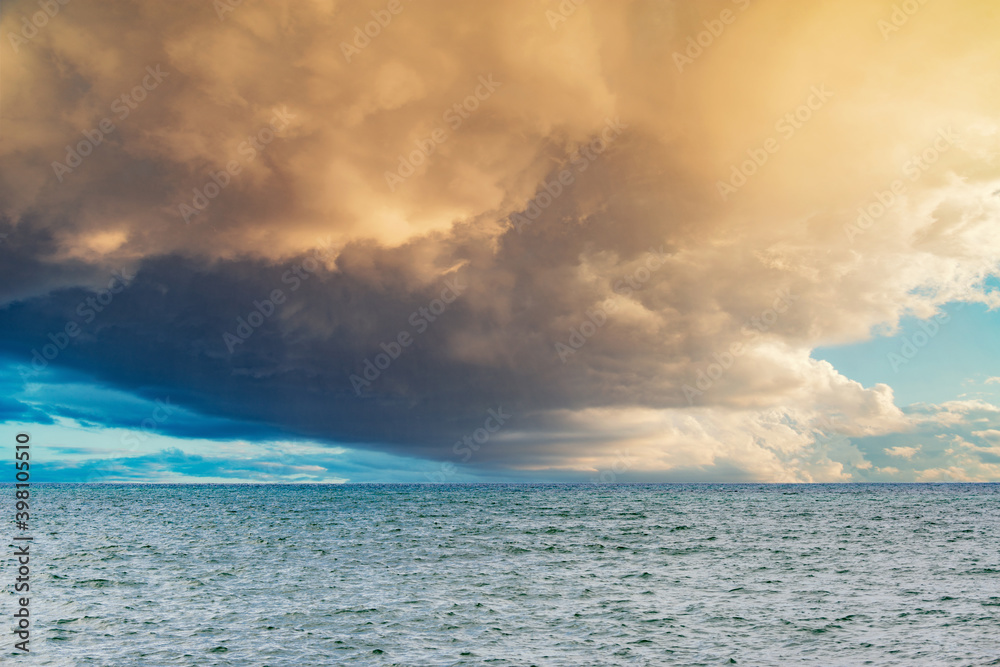 Stormy sky over the calm surface of the sea.