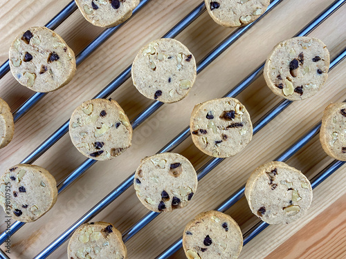 Warm, golden brown, chocolate chip cookies cooling on a rack.