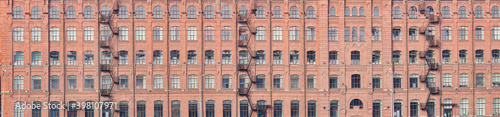 steel staircases and windows on old orange brick wall