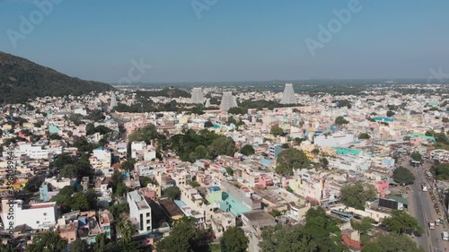 Aerial flyover colorful city in India with famous temple in background during sunny day and blue sky. photo