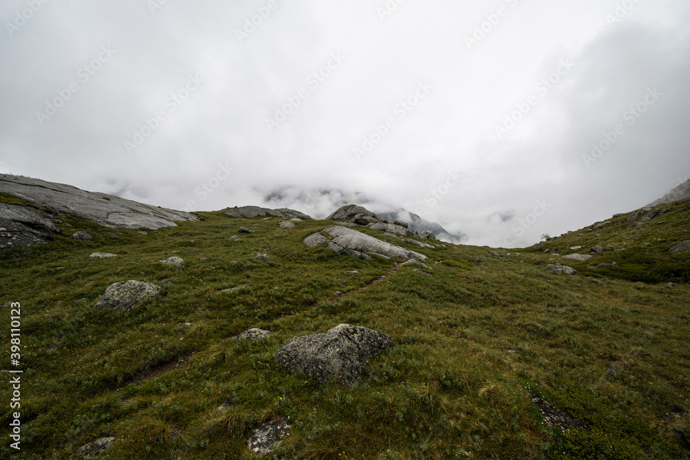 Altai mountains shrouded in white clouds, it looks quite gloomy Altai mountains shrouded in white clouds, it looks quite gloomy