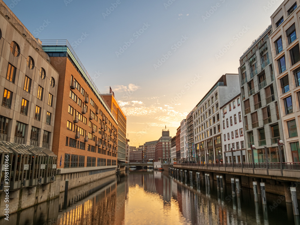Water street canal in Hamburg with high buildings during summer time