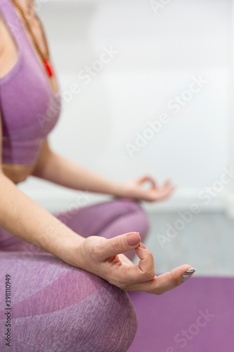 Close up of unrecognizable person practicing yoga in meditation posture.Vertical view. Space for text.