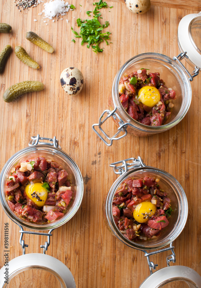 Steak tartare. Classic American restaurant or French bistro appetizer classic. Steak diced, mixed with eggs, red onions, olive oil, lemon juice, garlic and capers. Served with garlic bread. Steak tartare. Classic American restaurant or French bistro appetizer classic. Steak diced, mixed with eggs, red onions, olive oil, lemon juice, garlic and capers. Served with garlic bread.