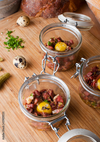 Steak tartare. Classic American restaurant or French bistro appetizer classic. Steak diced, mixed with eggs, red onions, olive oil, lemon juice, garlic and capers. Served with garlic bread.