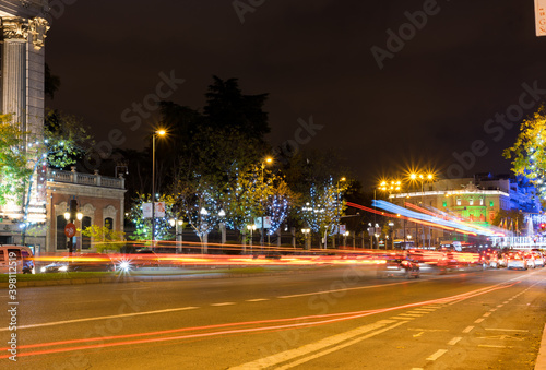 Madrid, Spain, November 28, 2020: The Alcalá Street is illuminated by the Christmas season, and with the trails of the vehicles. In the background, you can see the Cibeles Square © MasobPhoto
