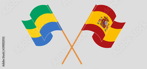 Crossed and waving flags of Gabon and Spain