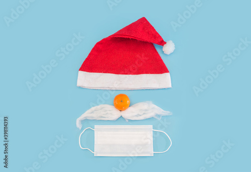 Santa Claus hat and beard with face mask on a blue background,