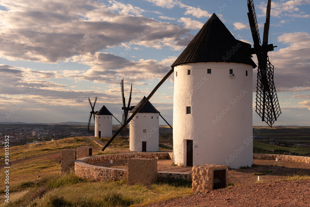 Exterior view of windmills on landscape in spring in Alcazar de San Juan, Ciudad Real, Spain