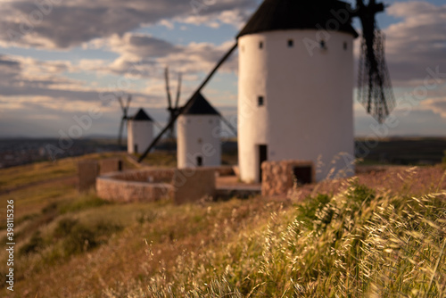 Exterior view of windmills on landscape in spring in Alcazar de San Juan, Ciudad Real, Spain
